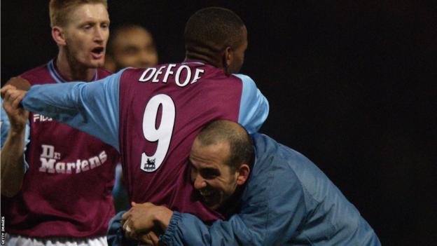 Paolo di Canio hugs Jermain Defoe during their time together at West Ham