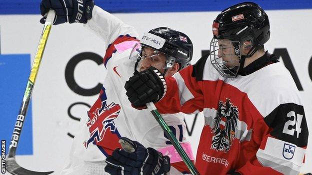 Austria's forward Marco Kasper checks Great Britain's forward Ben Lake during the IIHF Ice Hockey World Championships