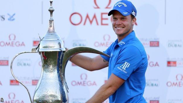 English golfer Danny Willett celebrates winning the Omega Dubai Desert Classic