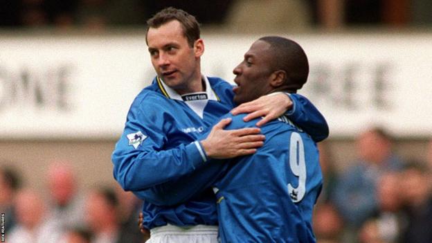 Kevin Campbell celebrates with Don Hutchison after scoring the first of his two goals against Newcastle in April 1999