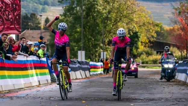 Two cyclists celebrating at the finish line