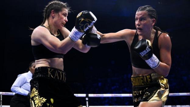 Katie Taylor tries to block a punch from Chantelle Cameron