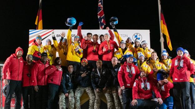 Gulliver and the GB team celebrate on the podium after their World Cup gold
