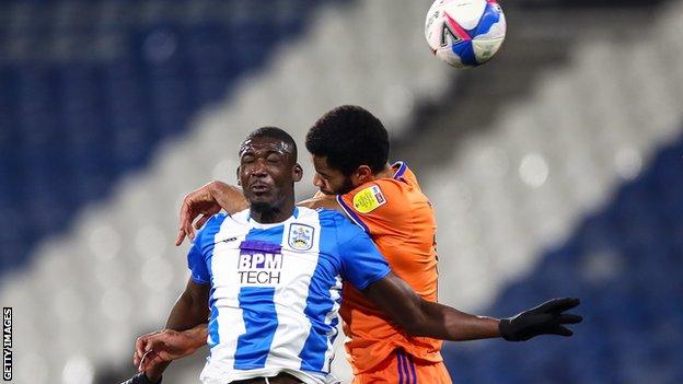 Curtis Nelson challenges Yaya Sanogo, who was making his first Huddersfield start