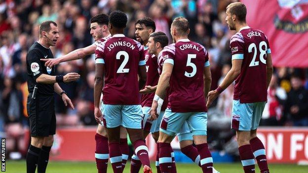 West Ham players surround referee Peter Bankes complaining about Southampton's opening goal in the 1-1 draw.