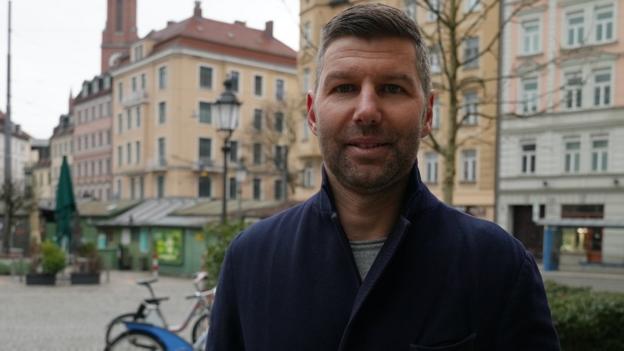 Thomas Hitzlsperger stands in a square in Berlin