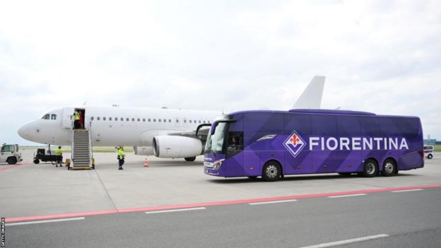 Fiorentina team coach at the airport near to a plane