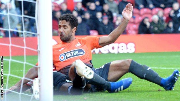 Wayne Routledge slides in to score Swansea's opening goal at Brentford