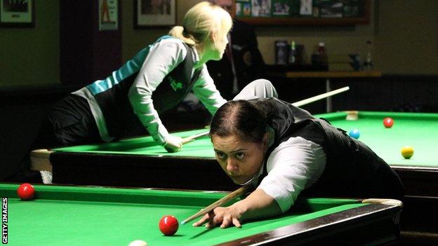 Women playing snooker.