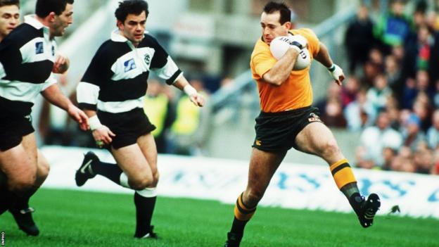 David Campese speeds away from Will Carling and Nick Popplewell during a contest between Australia and the Barbarians in 1992