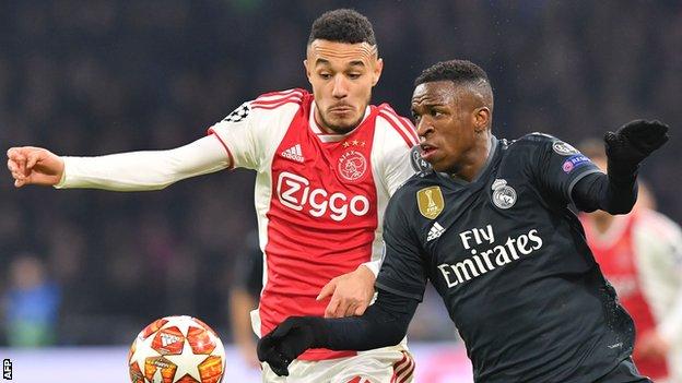 Ajax's Noussair Mazraoui takes on Vinicius Junior of Real Madrid in the Uefa Champions League
