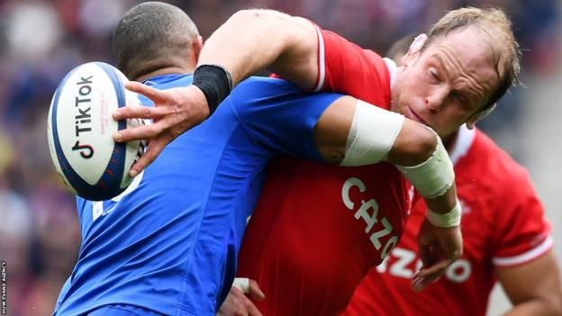 Alun Wyn Jones of Wales is tackled by Gael Fickou of France