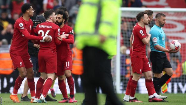 Andrew Robertson is held backmost  by team-mates aft  a confrontation with the adjunct  referee