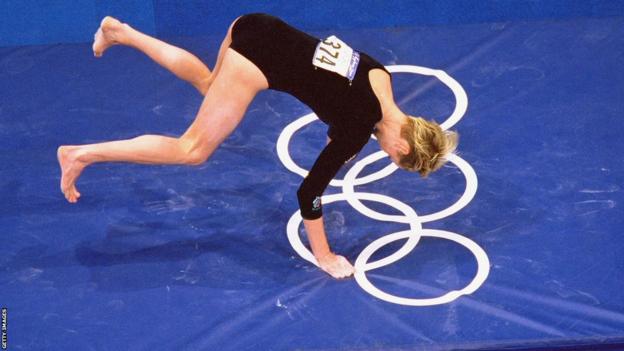 Svetlana Khorkina falls while competing on the vault in the all-around final at Sydney 2000