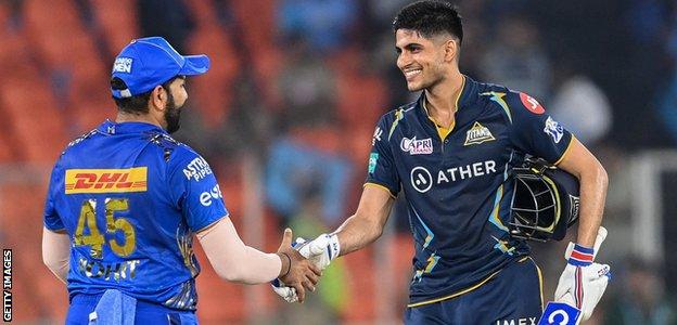 Shubman Gill, right, shakes hands with Rohit Sharma in an IPL game