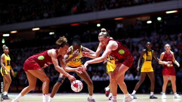 Serena Guthrie and Jo Hartnet of Vitality Roses and Kadie Ann Dehaney of Jamaica battle for the ball