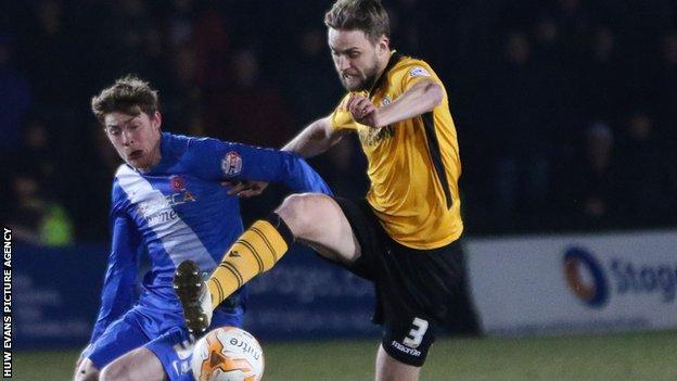 Newport County's Mark Byrne and Jake Carroll of Hartlepool compete for the ball