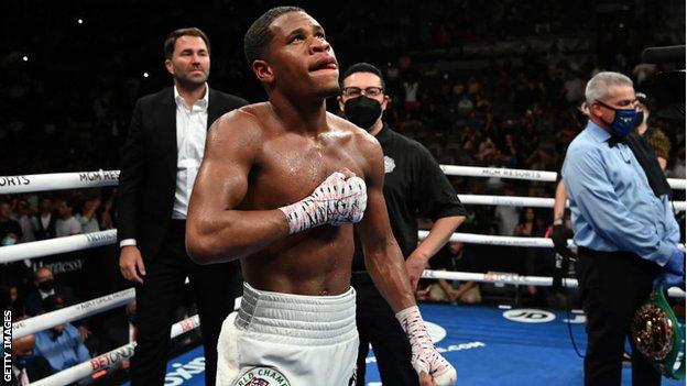 Devin Haney looks up to the sky after winning a fight