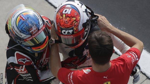Romain Grosjean and Charles Leclerc congratulate Pierre Gasly