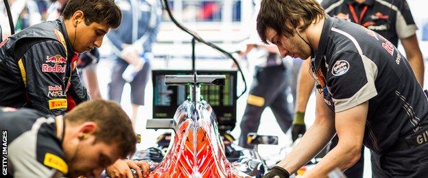 Mechanics work on a Scuderia Toro Rosso car during the 2016 F1 season