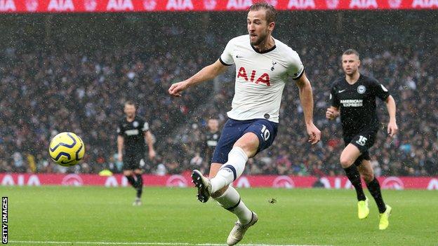 Tottenham striker Harry Kane scores against Brighton