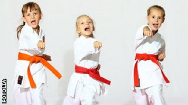 Three girls doing karate