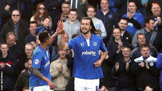 Christian Burgess (right) celebrates Portsmouth's third goal against Notts County