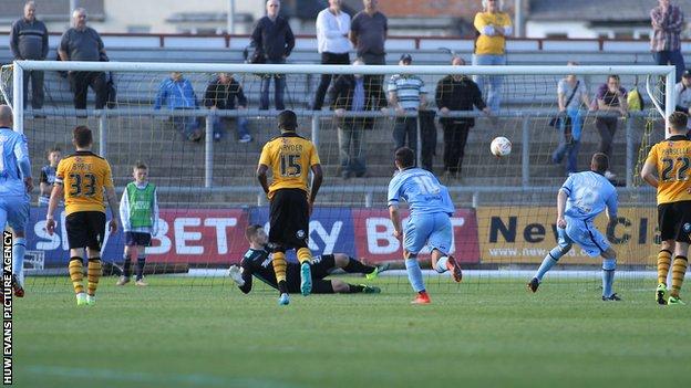 Paul Mullin sends Newport goalkeeper Joe Day the wrong way from the spot