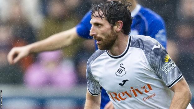 Joe Allen competes for the ball