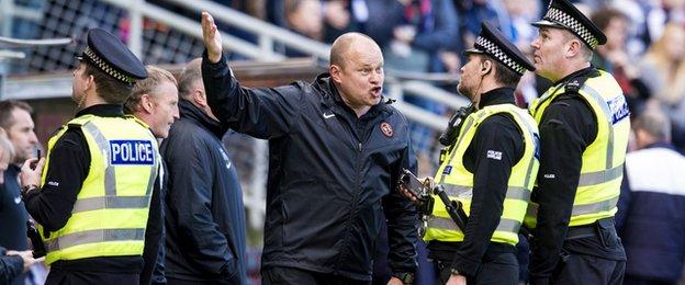 Dundee United boss Mixu Paatelainen gestures to police over abuse he claimed he received from Dundee fans