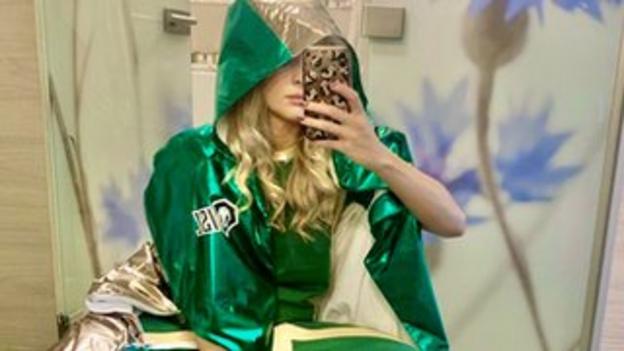 Siobhan-Marie O'Connor takes a selfie wearing a green embroidered cape