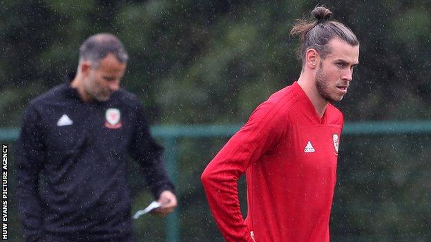 Gareth Bale in training with Wales under the watchful eye of Ryan Giggs