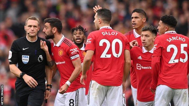 Manchester United's players, led by Bruno Fernandes, remonstrate with referee Craig Pawson during the draw with Newcastle.