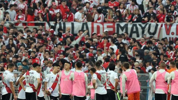 River Plate footballers react after their match against Defensa y Justicia is suspended after a spectator fell from the top of a grandstand at the El Monumental stadium in Buenos Aires