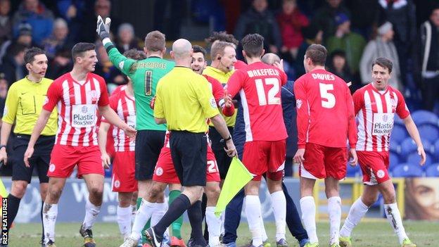 Accrington players appeal with Trevor Kettle
