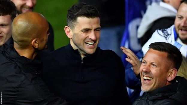 Portsmouth manager John Mousinho celebrates winning League One