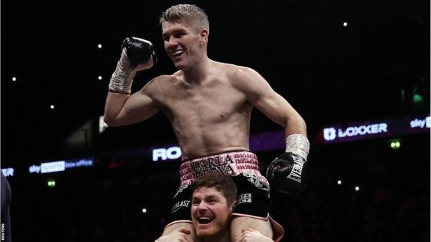 Liam Smith is lifted up by his trainer Joe McNally