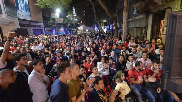 Fans of Egypt's Al Ahly watch the 2018 African Champions League final against Tunisia's Esperance on the streets of Cairo