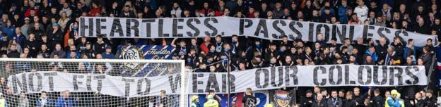 Rangers fans hold banners at St Mirren