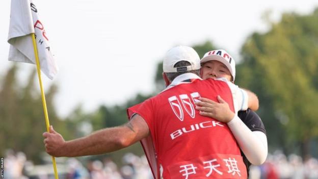Angel Yin celebrates with her caddie in Shanghai