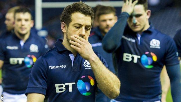 Scotland captain leads off his dejected team after defeat by England
