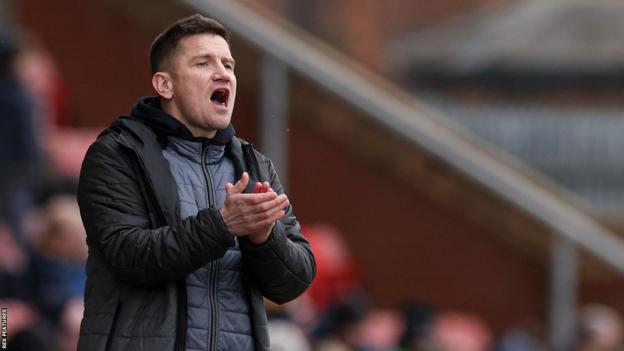 Crewe boss Lee Bell shouts instructions to his players from the touchline