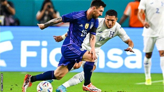 Lionel Messi fights for the ball with Hector Castellanos of Honduras