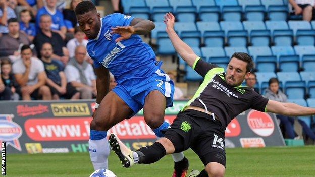 Cheltenham's Ryan Jackson is tackled by Nicky Clark for Bury