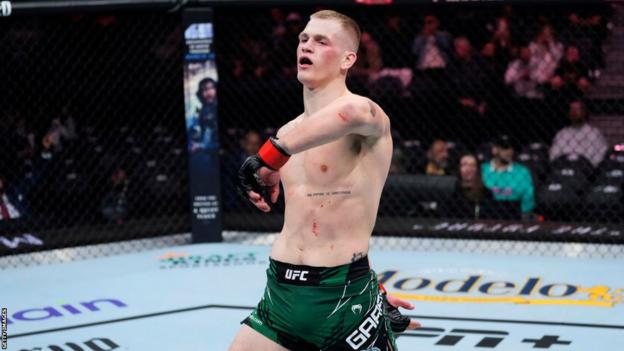 Ian Garry celebrates after beating Song Kenan at UFC 285 in March