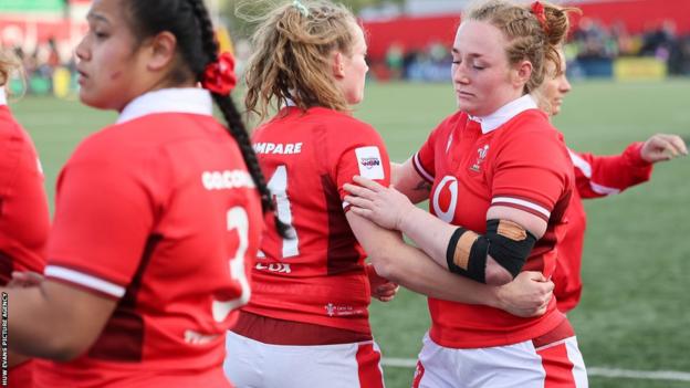 Abbie Fleming and Carys Cox console each other in defeat
