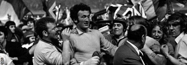 Rangers goalkeeper Peter McCloy is mobbed by fans at full-time