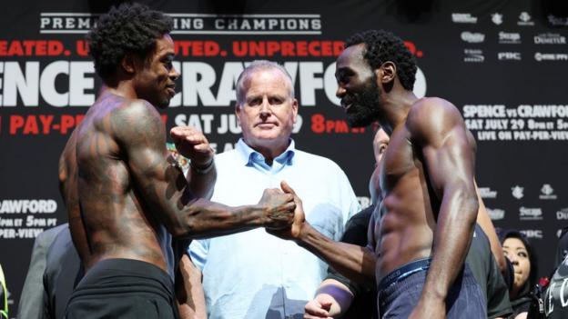 Errol Spence and Terence Crawford shake hands during a face-off