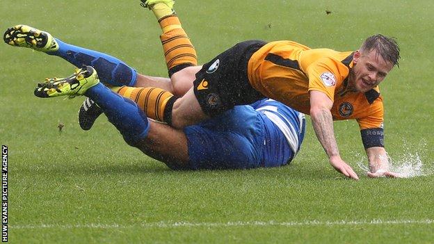 Mark Byrne of Newport County is tackled by Cole Kpekawa of Queens Park Rangers