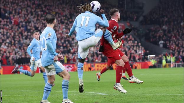 Manchester City's Jeremy Doku challenges Liverpool's Alexis Mac Allister in the final seconds of their 1-1 Premier League draw